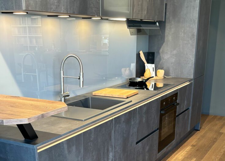 Einzeilige graue Küche mit Arbeitsplatte in Beton-Optik
