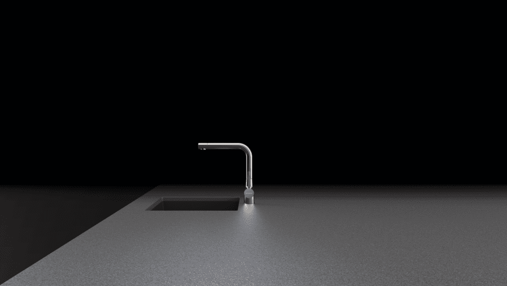Moderne, minimalistische L-förmige Küchenarmatur von Schock über einem schwarzen Spülbecken.